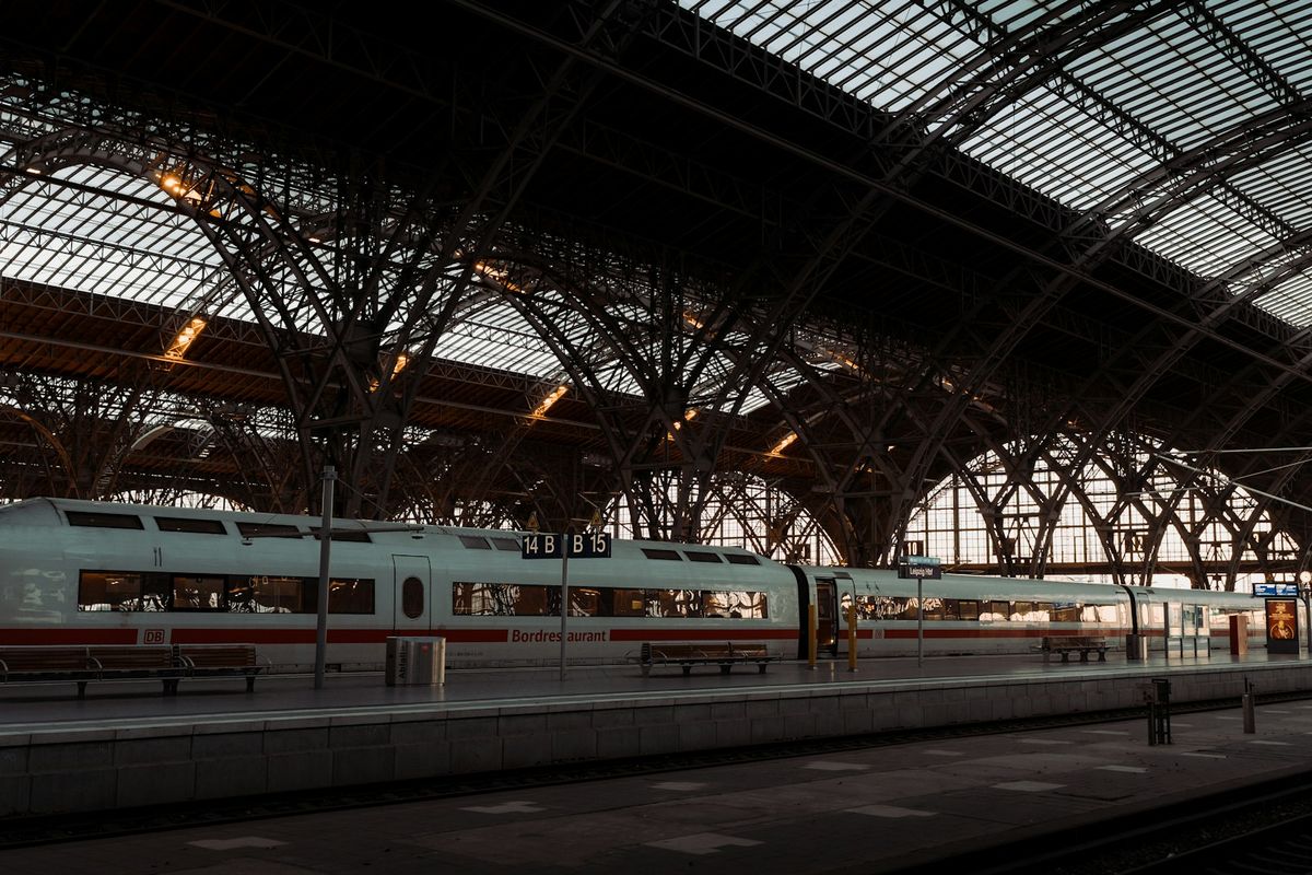 Modern sleeper train at a grand European station with arched ceiling