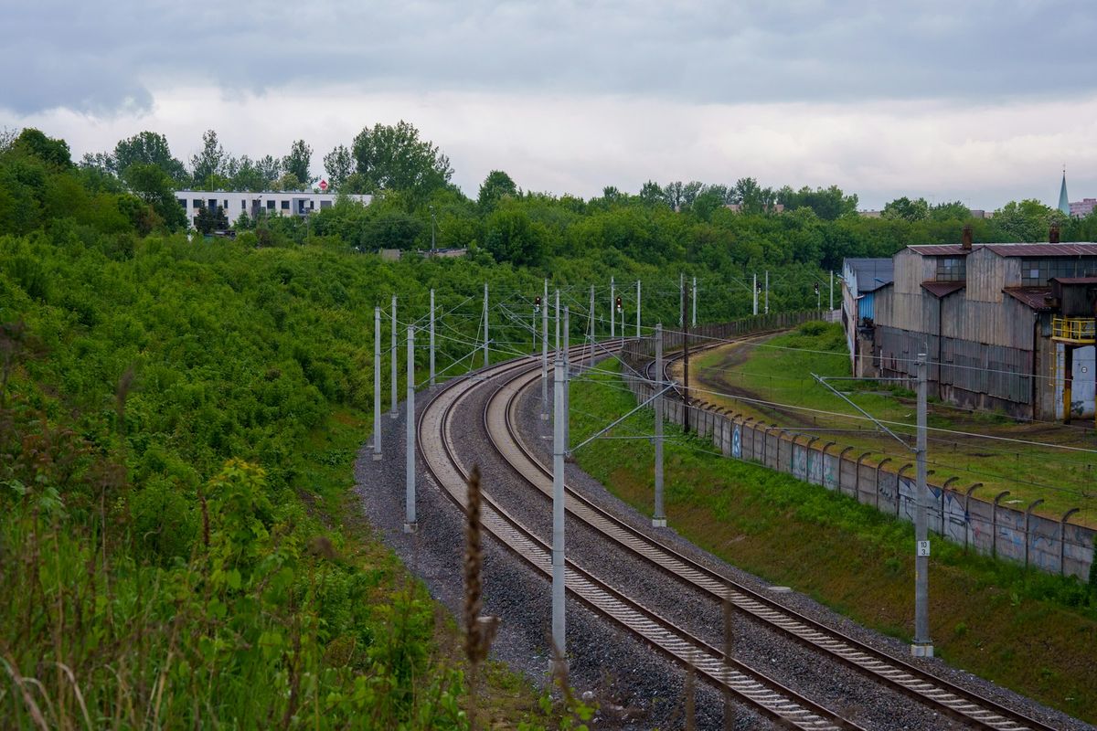 Train tracks curving through green Polish landscape