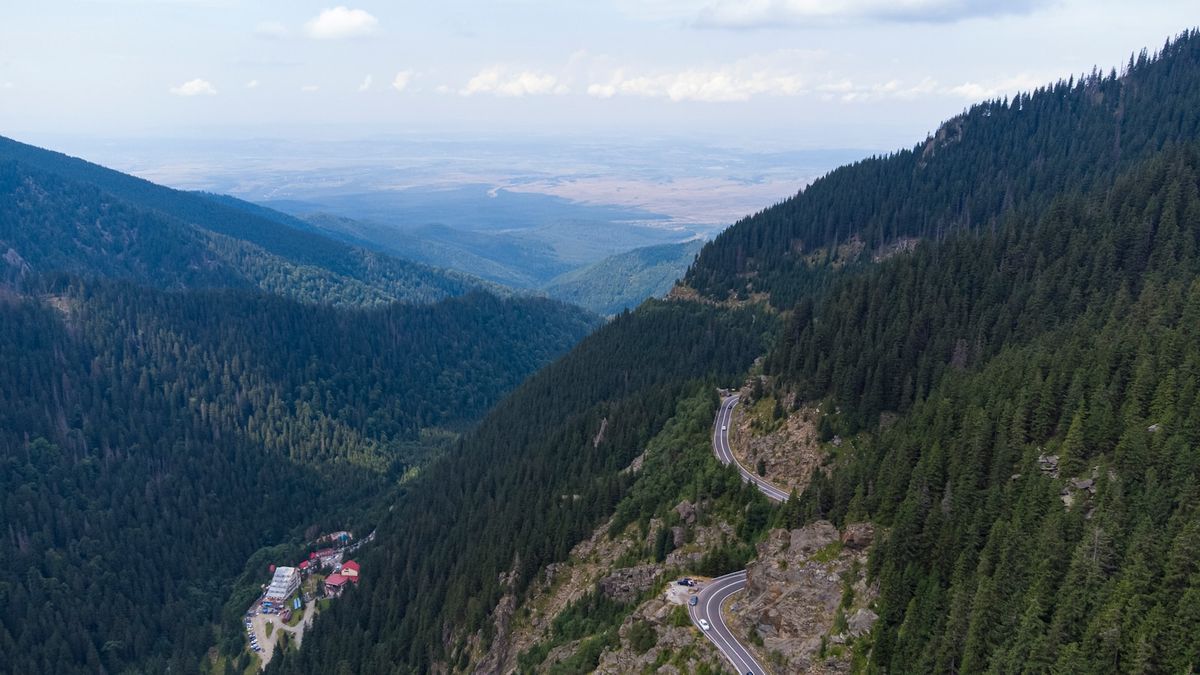 Aerial view of green Carpathian mountains and valleys in Romania