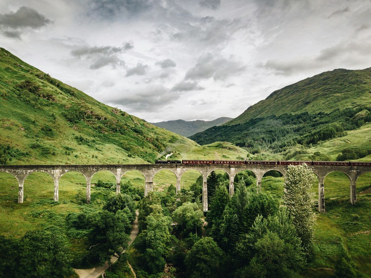 Scenic train crossing a viaduct in the Scottish Highlands
