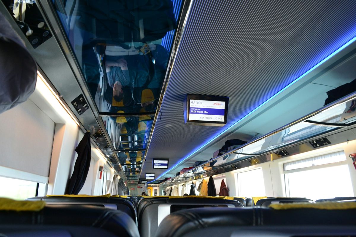 Interior of a modern European train carriage with rows of seats