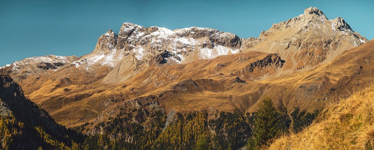 Snow-capped Swiss Alps with golden autumn foliage Golden Pass