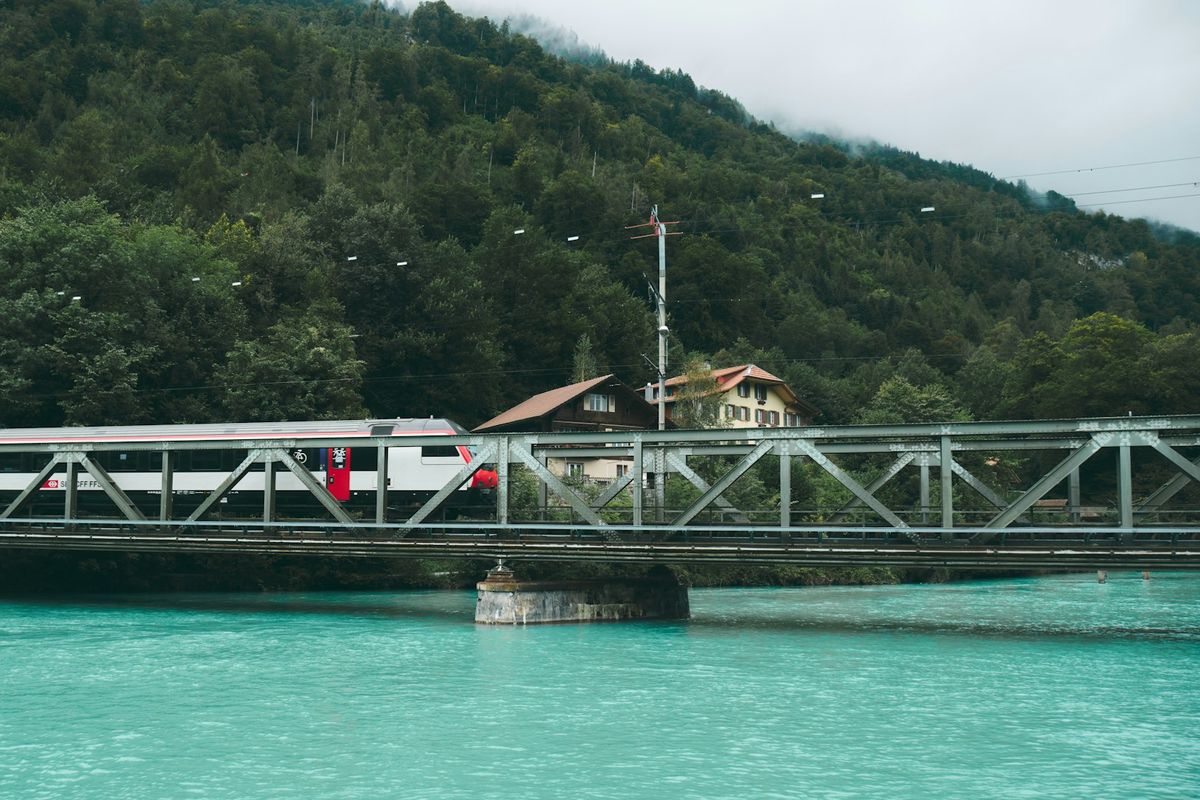 Train crossing a bridge over a lake in the Swiss Alps near Interlaken
