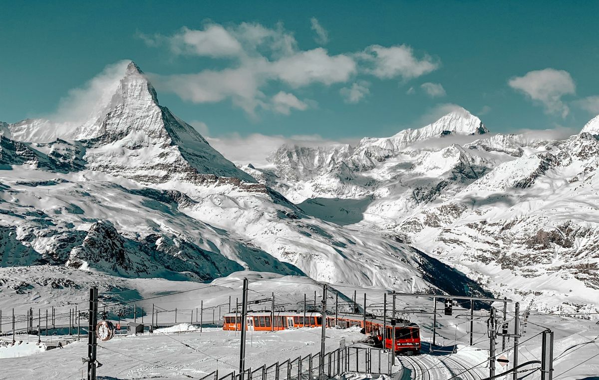 Snow-covered Matterhorn mountain peak under blue sky, Zermatt