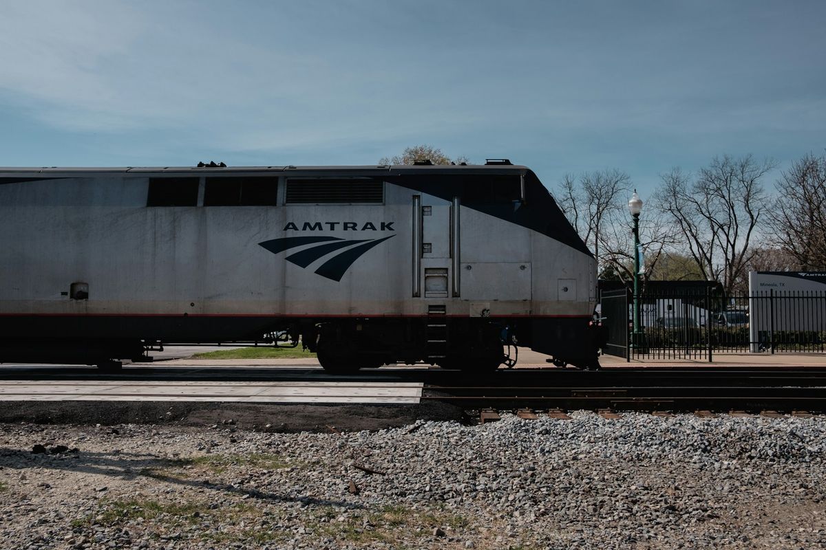 Train on railroad tracks through the American countryside