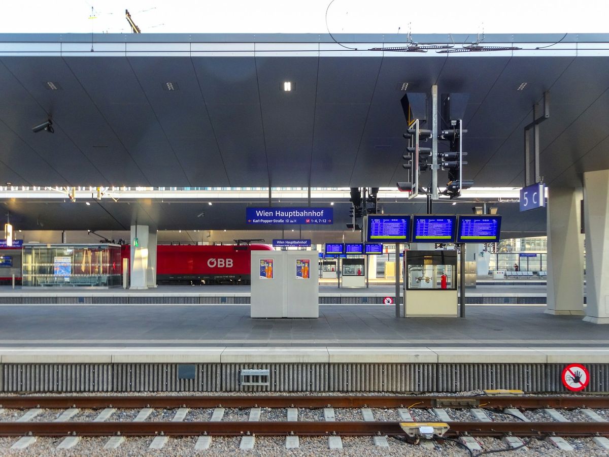 Modern train station platform with digital displays in Vienna