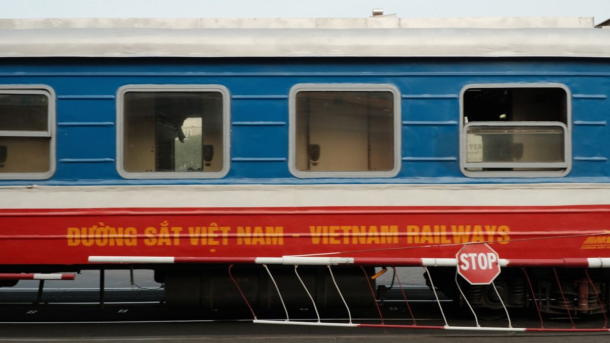 Blue and red Vietnam Railways train carriage on the tracks