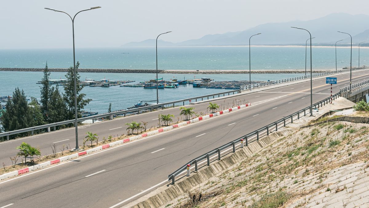 Coastal highway with ocean and mountains in Vietnam near Hai Van Pass