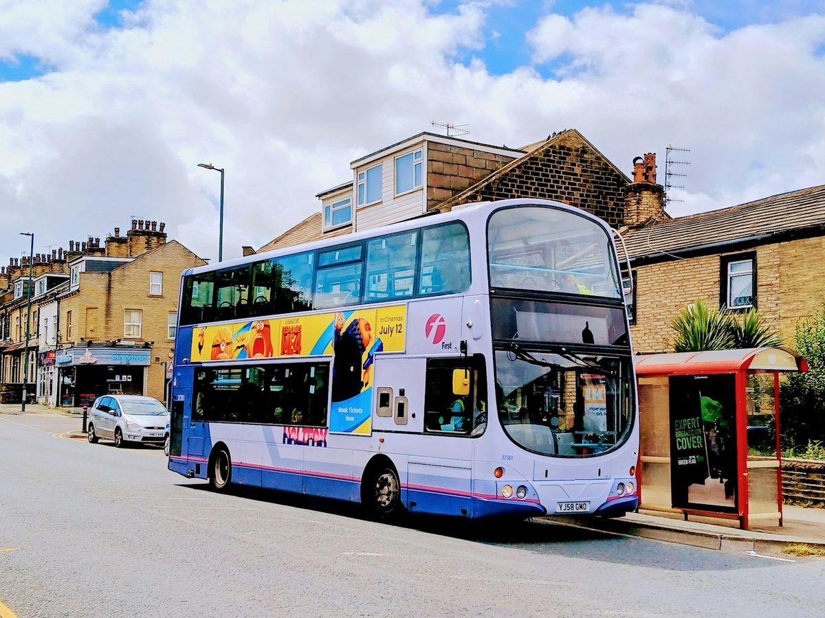 Bus at a stop on a UK street, the kind used for rail replacement service