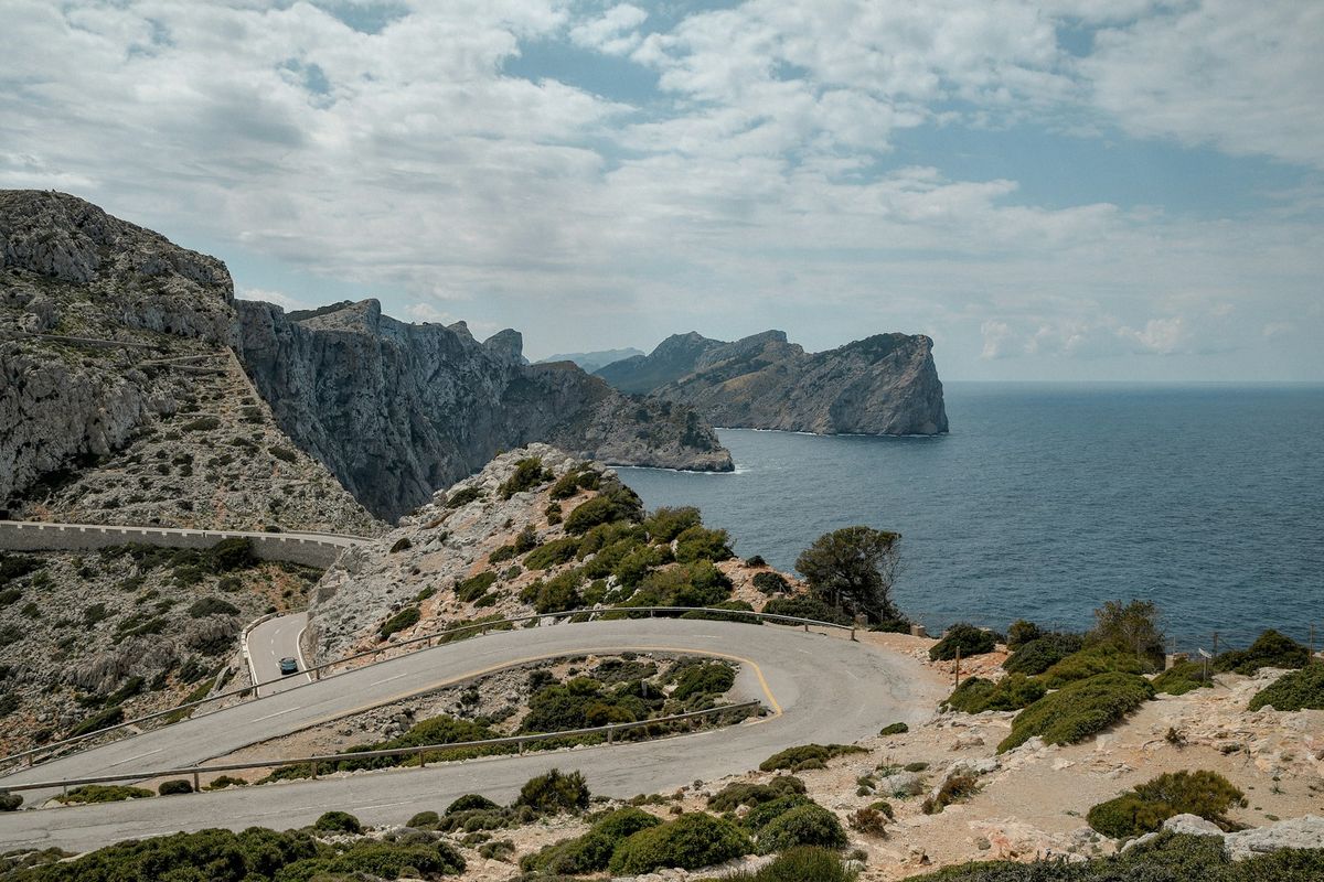 Winding coastal road along dramatic cliffs overlooking the ocean