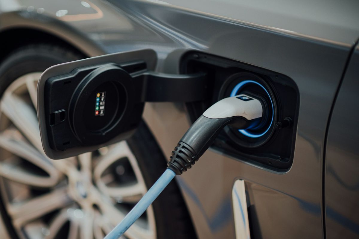 Close-up of an electric vehicle charging cable plugged in