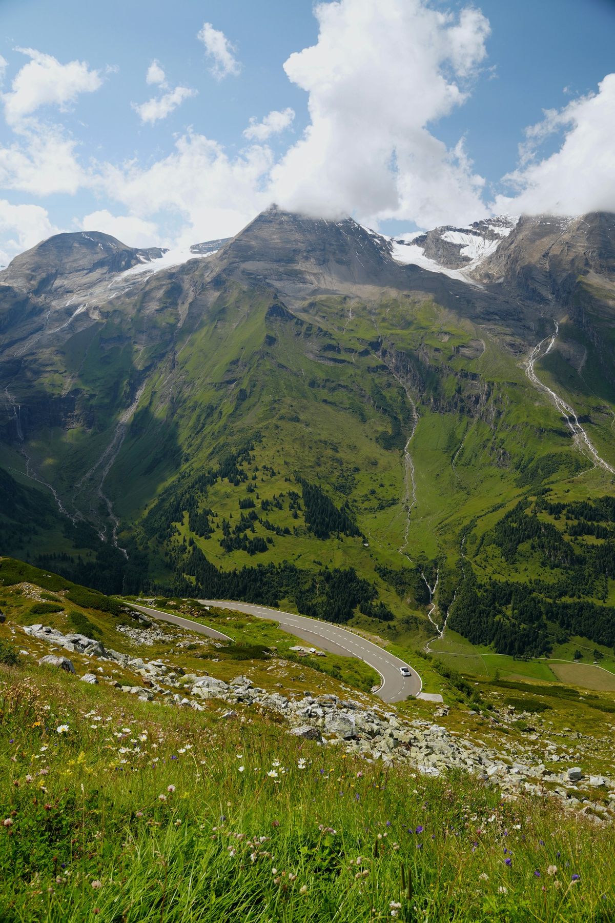 Winding mountain road through green alpine landscape in Austria