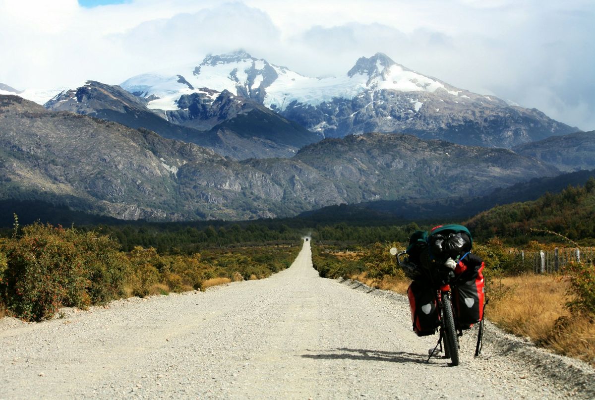 Gravel road toward glacier-capped mountains along Chile's Carretera Austral