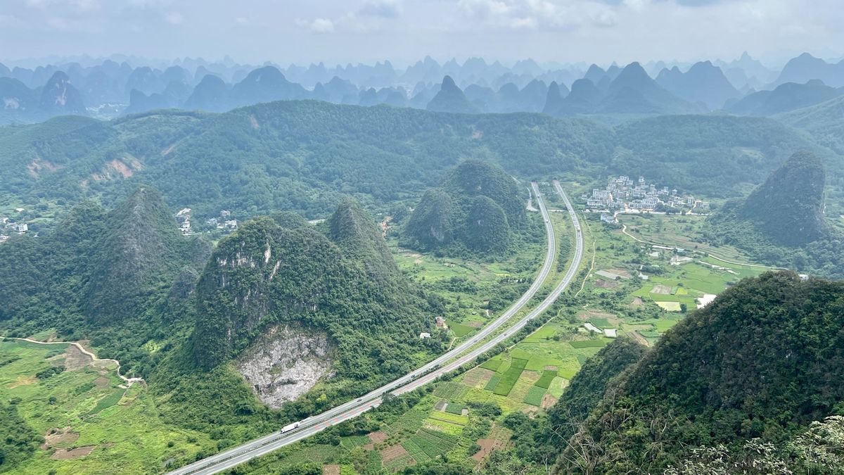 Scenic mountain road winding through green hills in China