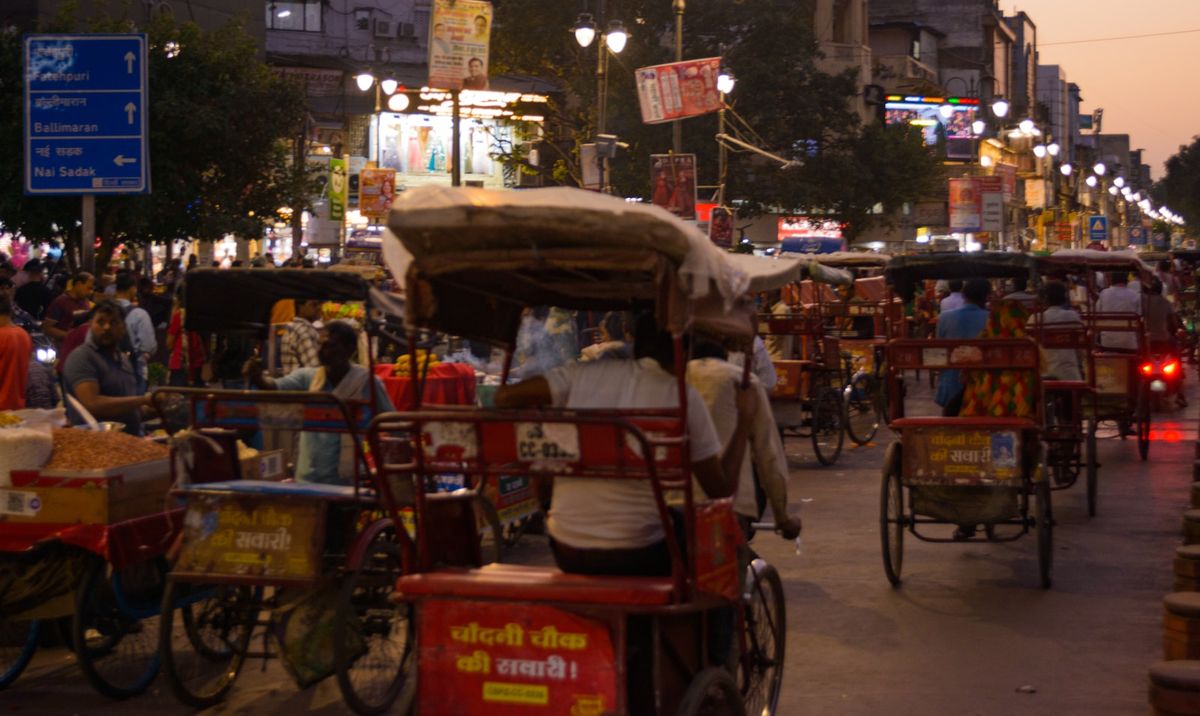 Busy street scene with rickshaws and pedestrians in India