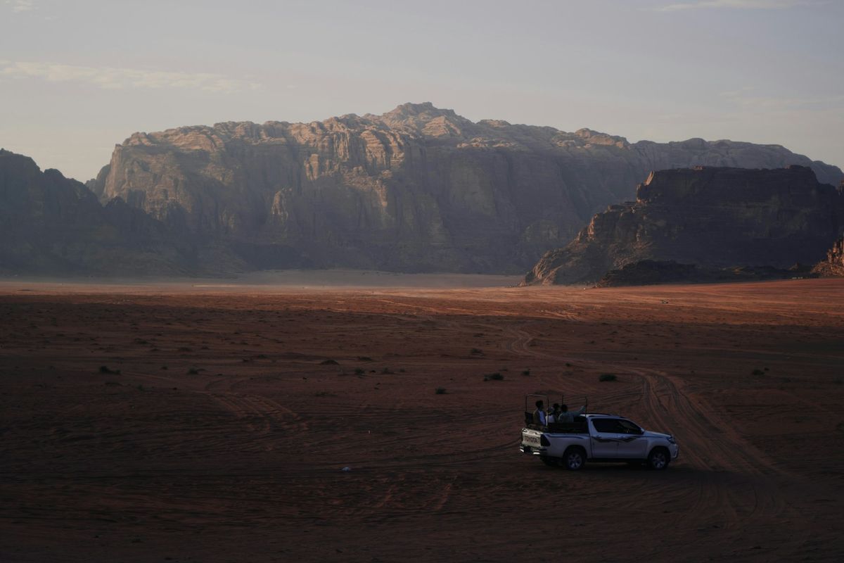 4x4 vehicle driving through the desert landscape of Wadi Rum, Jordan