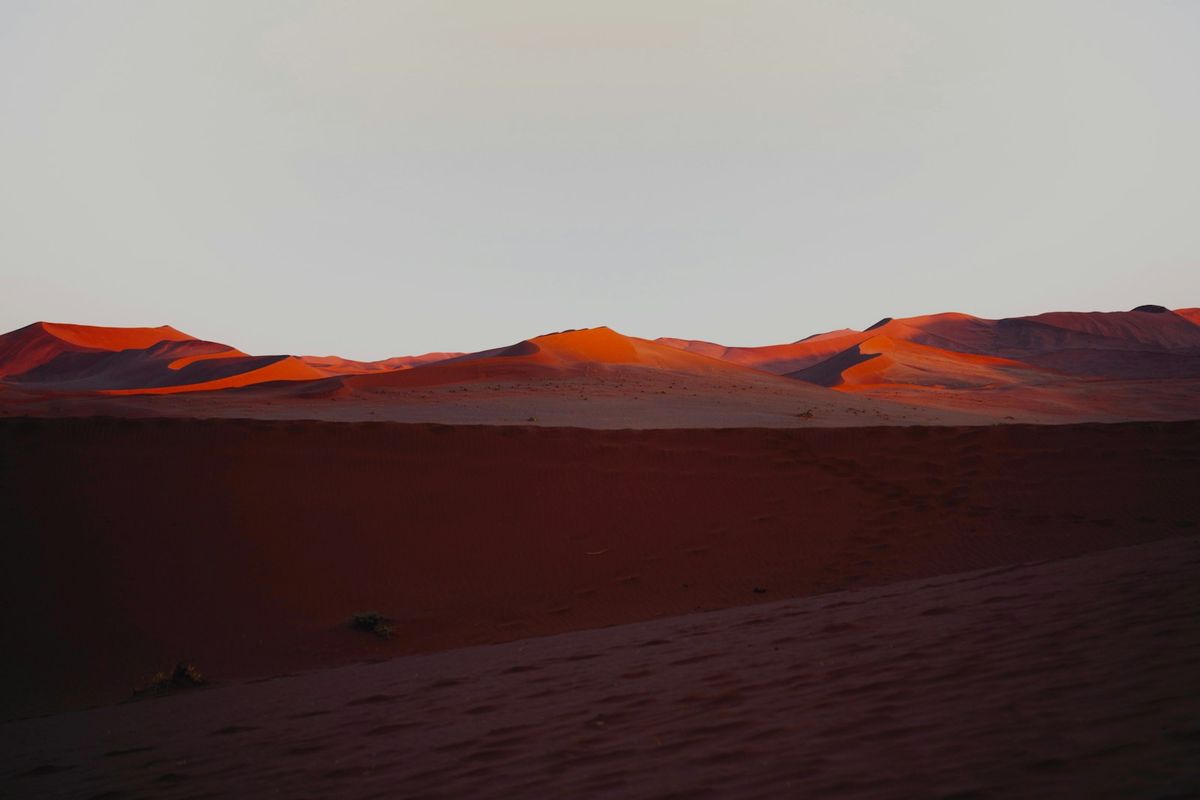 Red sand dunes glowing at sunset near Sossusvlei, Namibia