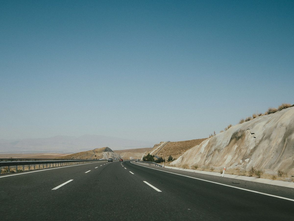 Black asphalt road through Cappadocia mountains Turkey