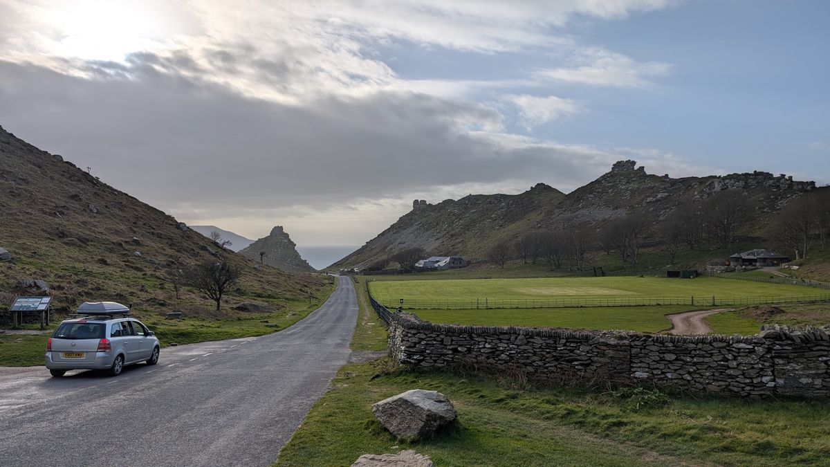 Car driving down a rural road through the countryside