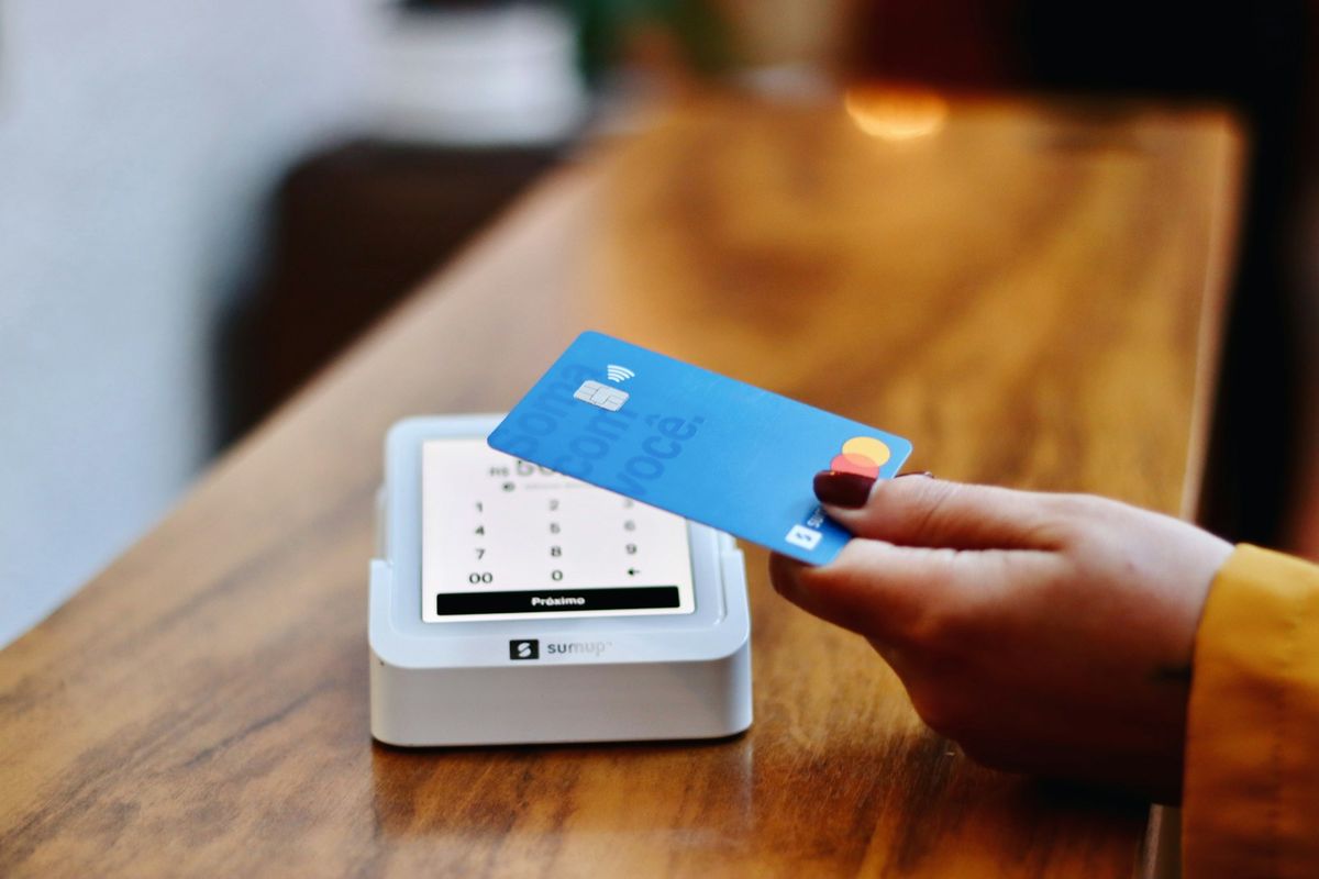 Person paying with a bank card at a payment terminal