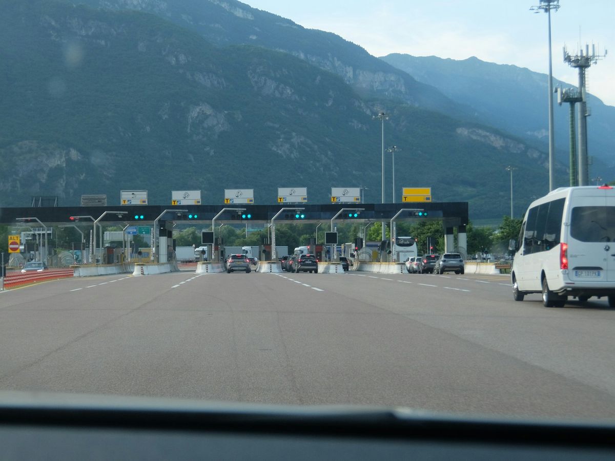 Cars approaching a multi-lane motorway toll booth
