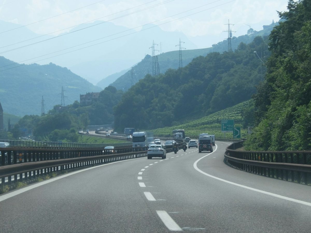 Cars and trucks on a European motorway through mountains