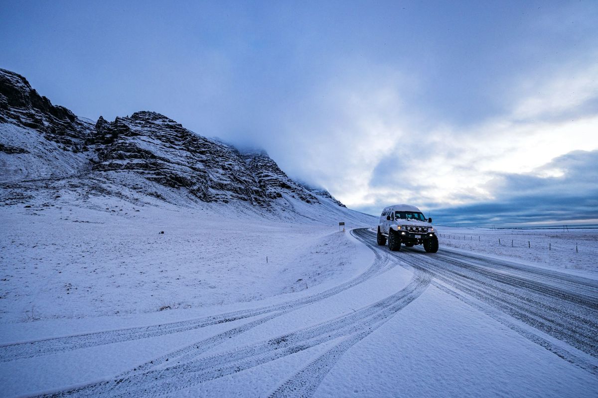 Car driving on a snowy mountain road in winter