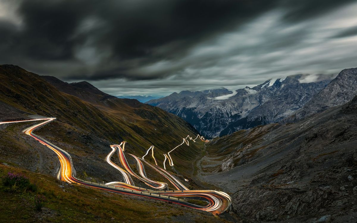 Winding alpine pass road through dramatic mountain scenery in the Dolomites