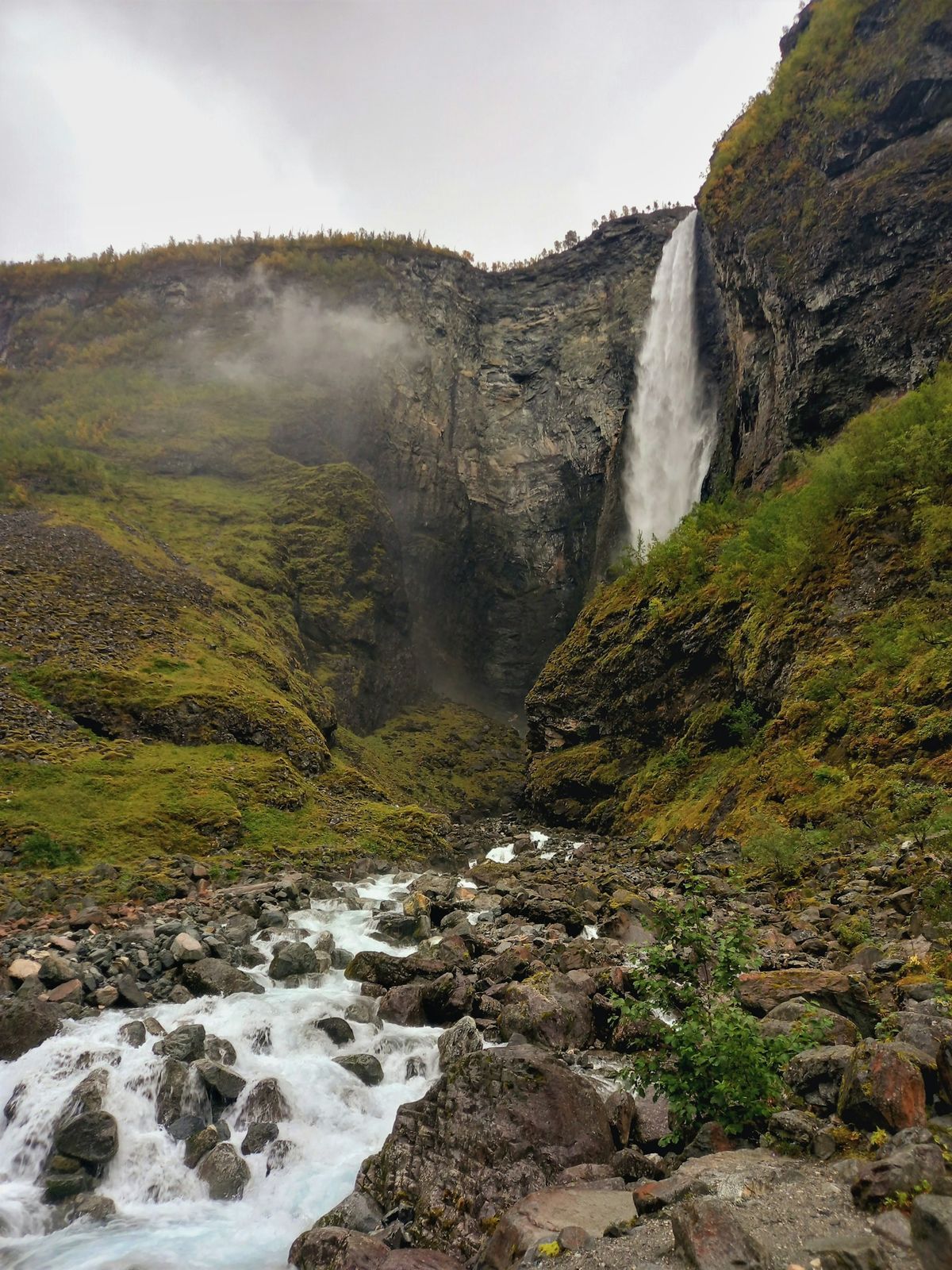 Multi-tiered Norwegian waterfall cascading down mountainside