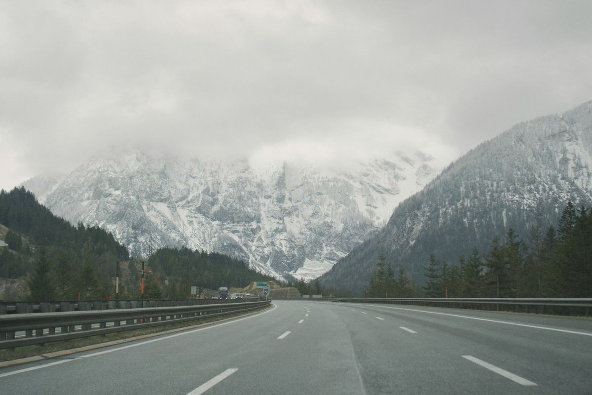 Highway with alpine mountains in the background