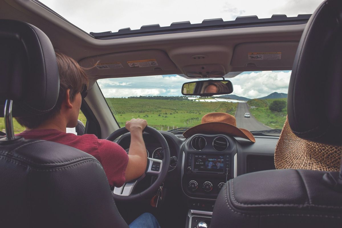 Young man driving a car looking ahead