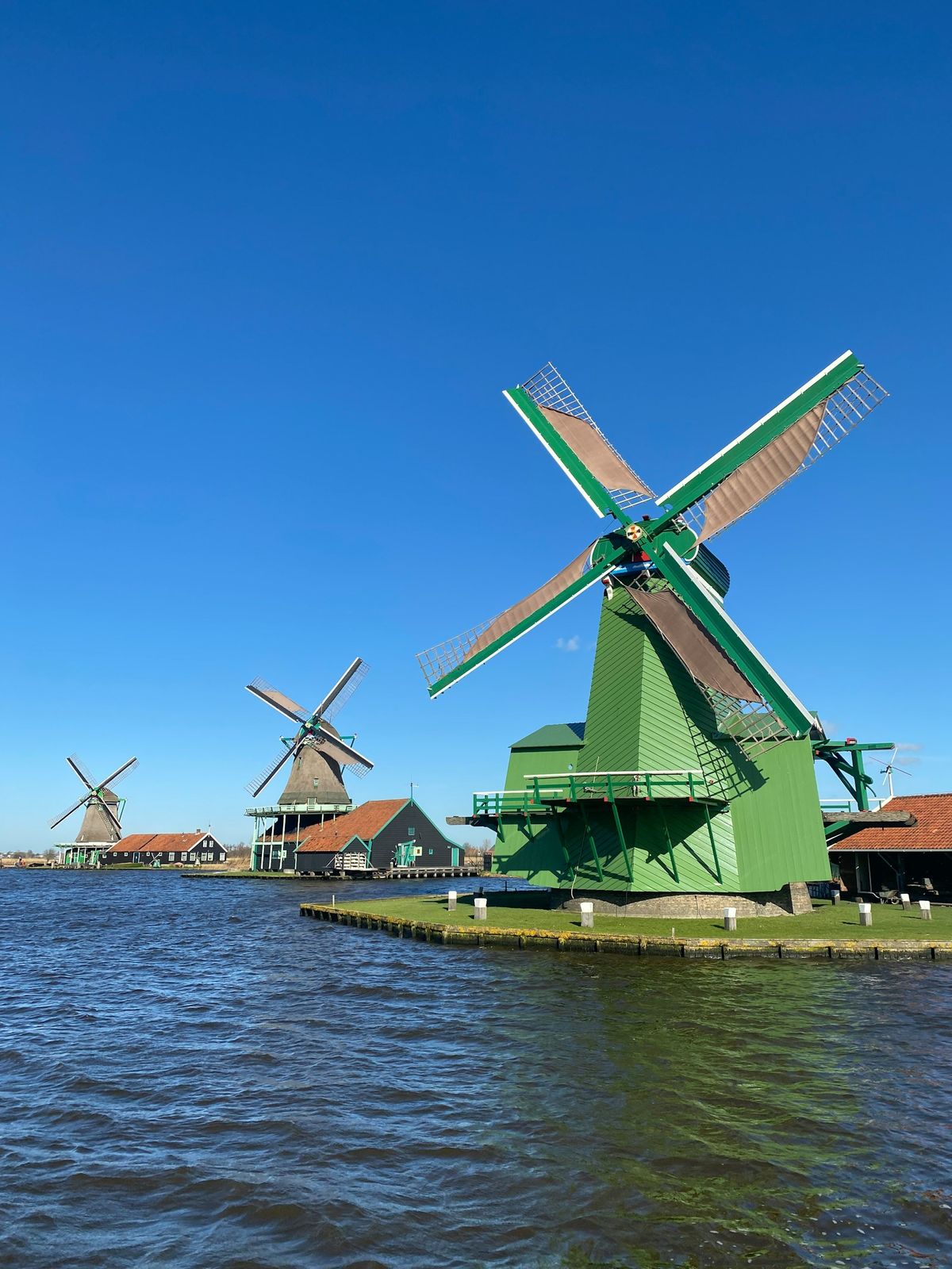 Traditional windmills by the water at Zaanse Schans, Netherlands