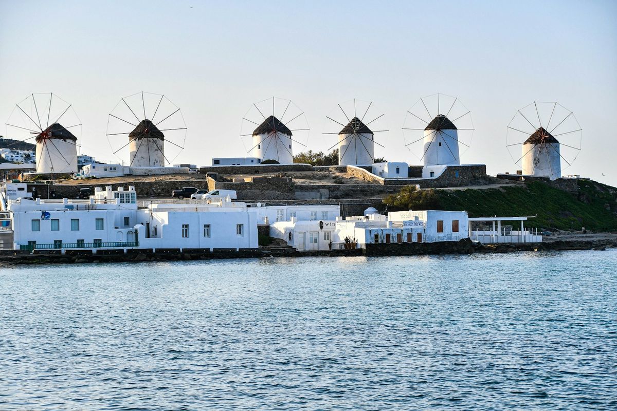 The iconic row of windmills overlooking the sea on Mykonos, Greece