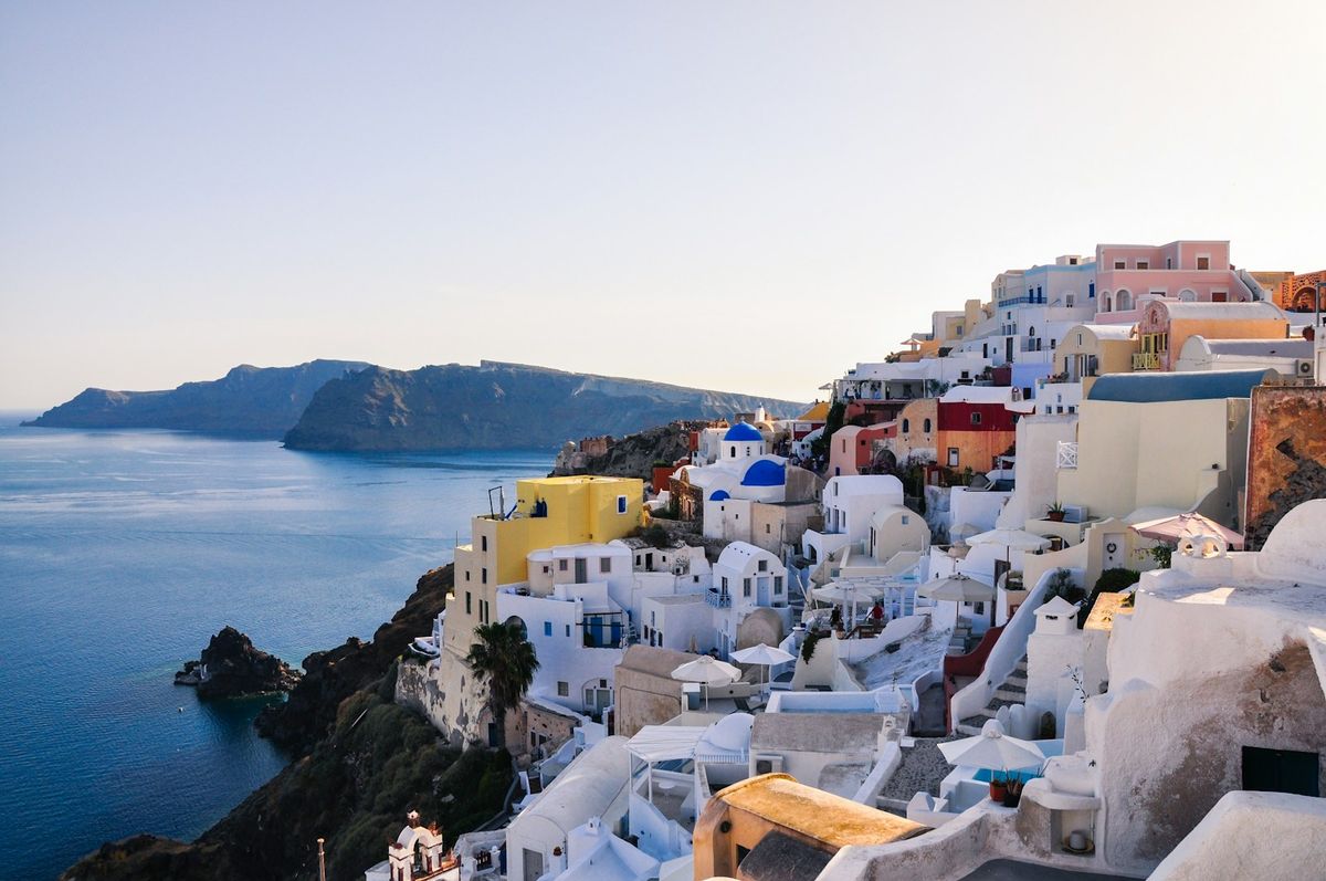 White and brown clifftop houses overlooking the sea in Santorini