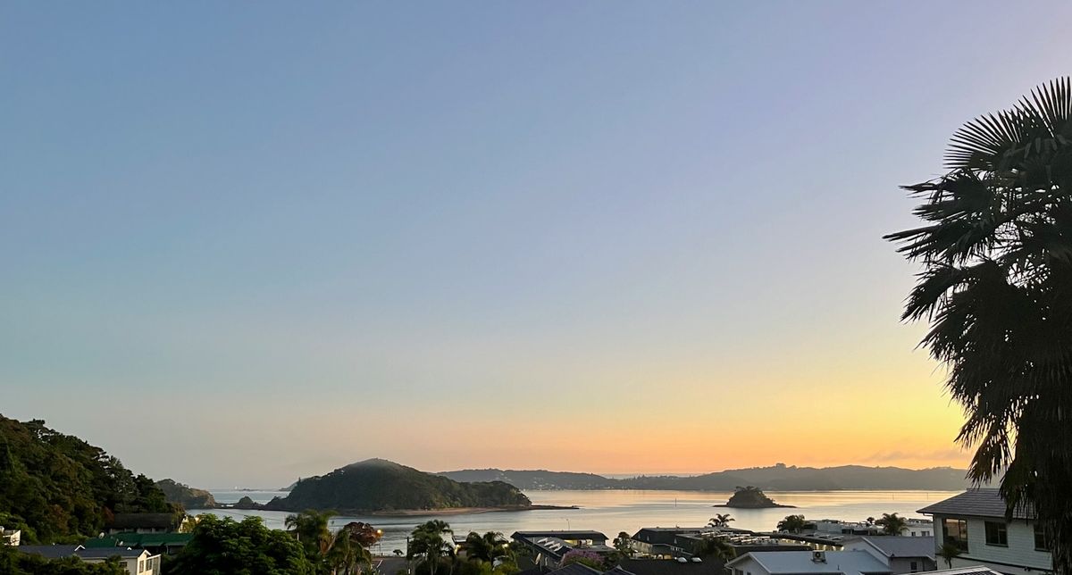 A view of a coastal town and turquoise bay in the Bay of Islands, New Zealand