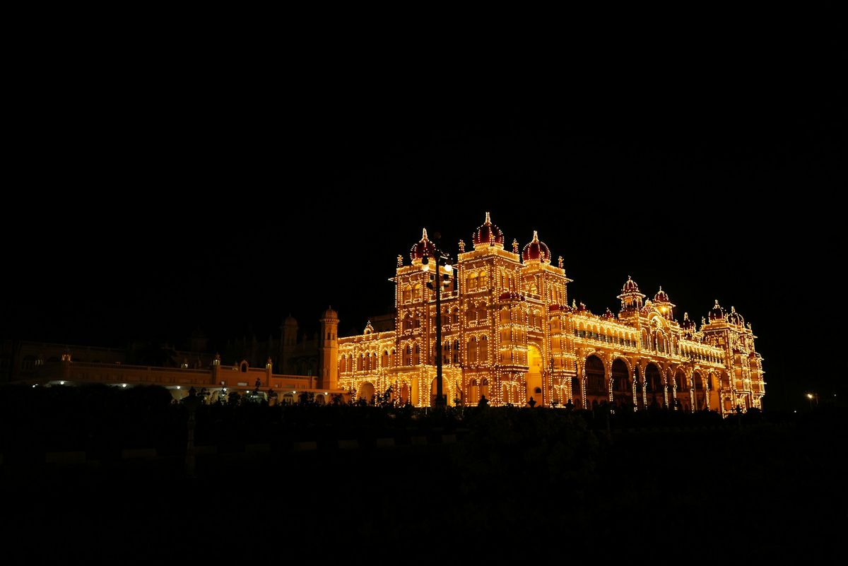 Mysore Palace ornately illuminated with lights at night