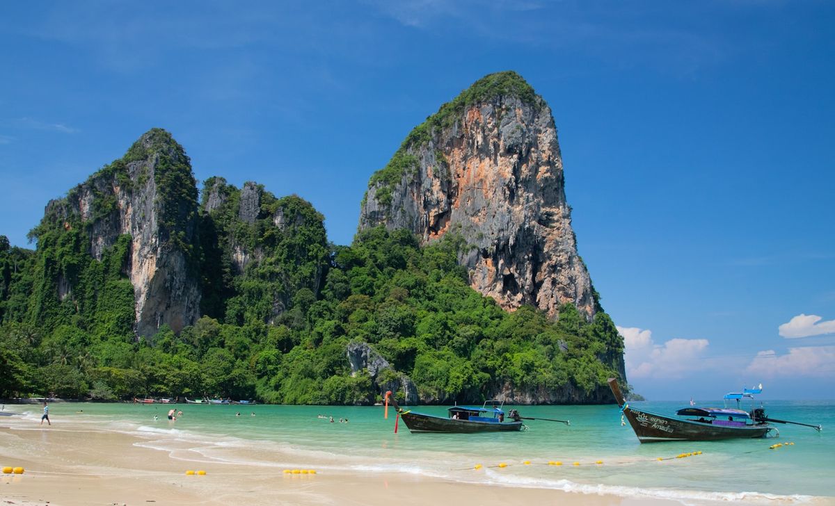 Boats and limestone cliffs at Railay Beach, Krabi