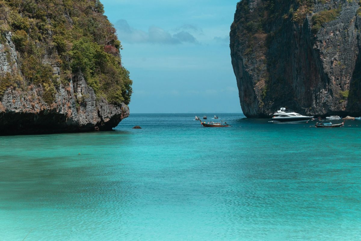 Turquoise water surrounds dramatic limestone cliffs in Phi Phi Islands, Thailand