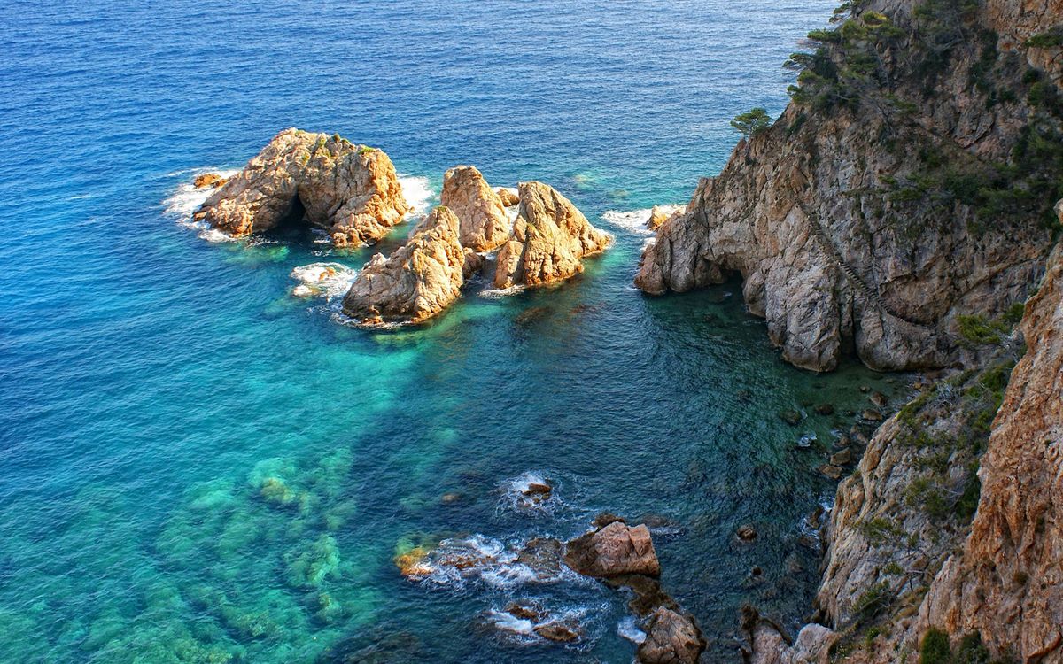 Turquoise cove and rocky cliffs at Illa des Palomar, Costa Brava