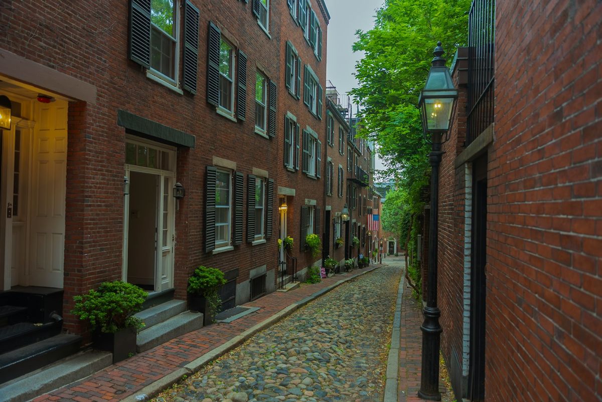 Historic cobblestone street lined with brick buildings in Salem, Massachusetts