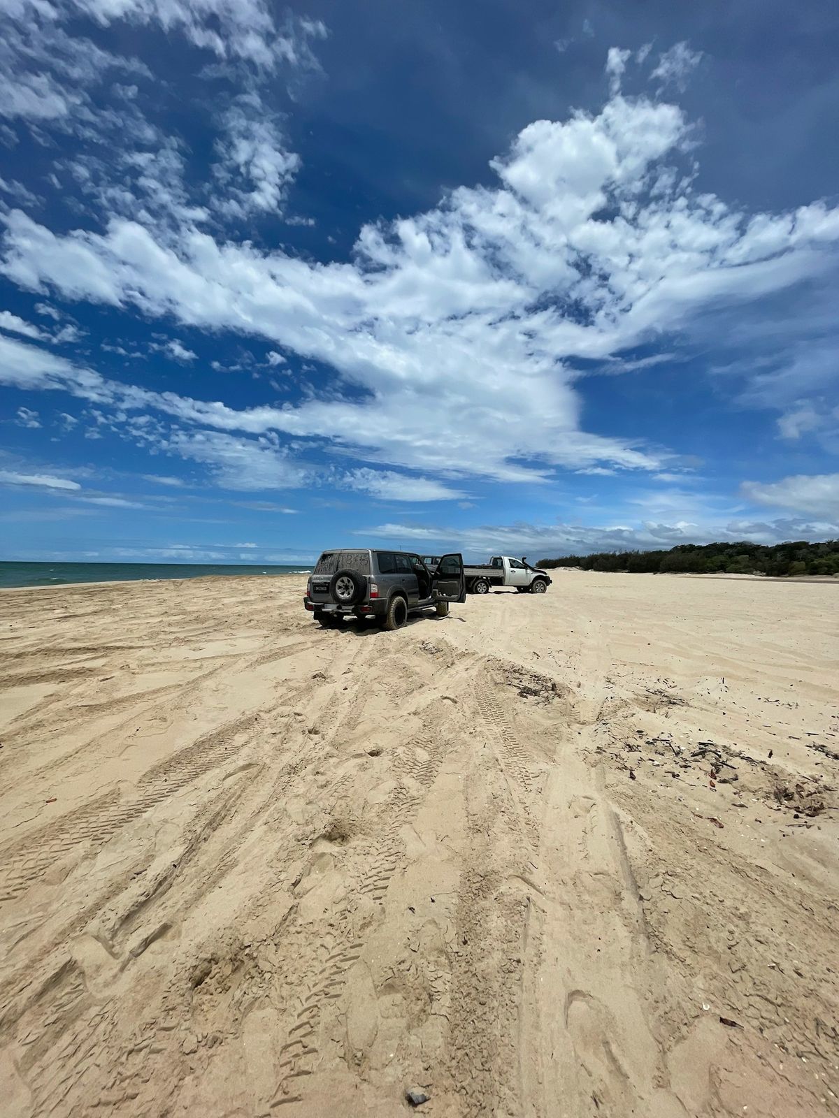 4WD vehicles parked on the sandy beach of Moreton Island