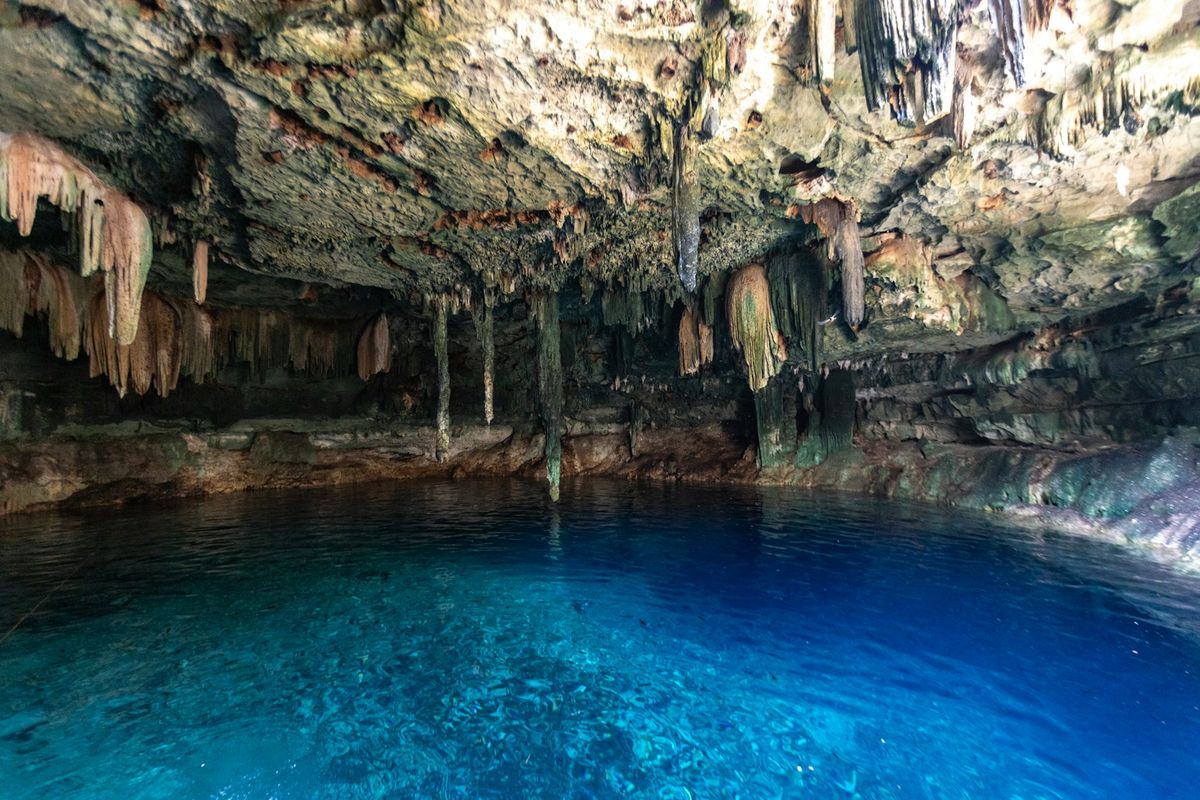 A cave cenote with clear blue water near Tulum, Mexico