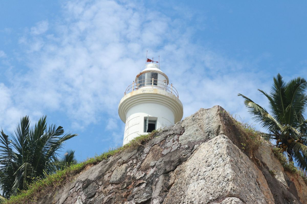 Galle Fort lighthouse on a rocky outcrop, Sri Lanka