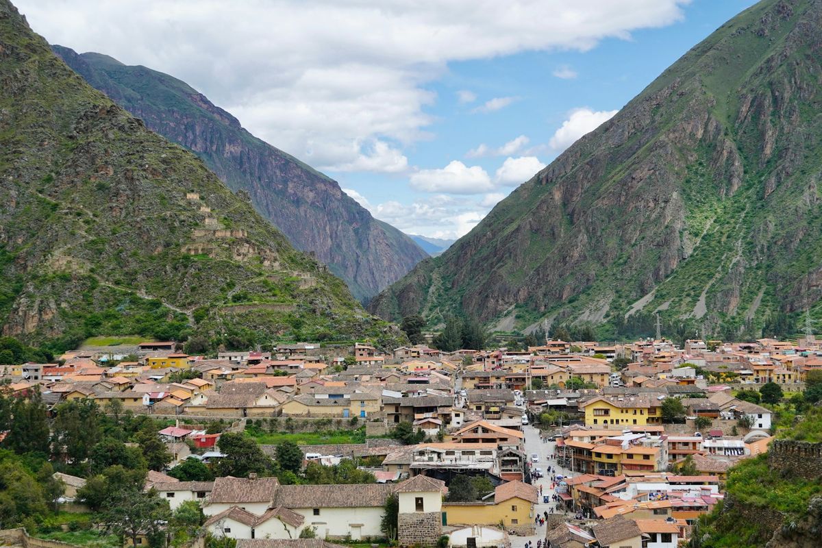 The town of Ollantaytambo nestled between steep mountains in Peru's Sacred Valley