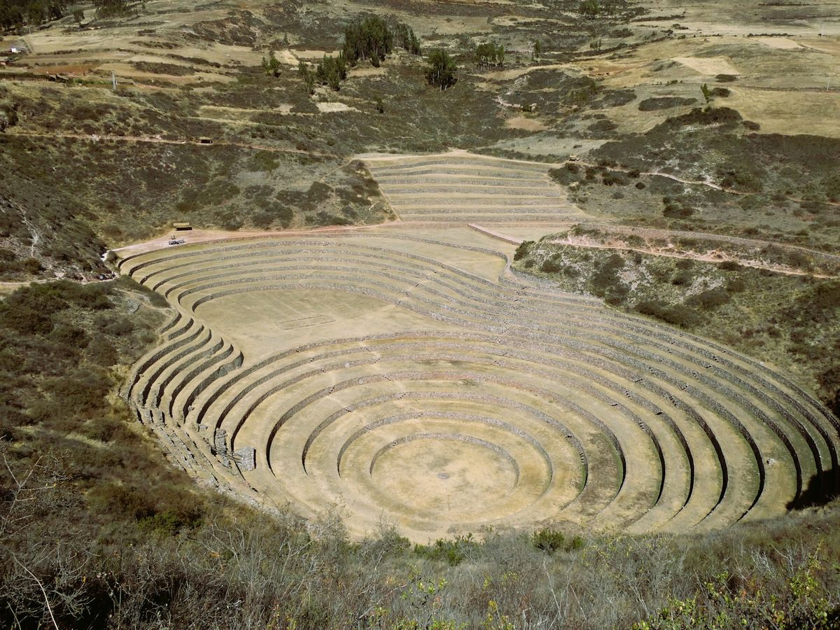 Circular Inca agricultural terraces carved into a hillside in the Sacred Valley of Peru