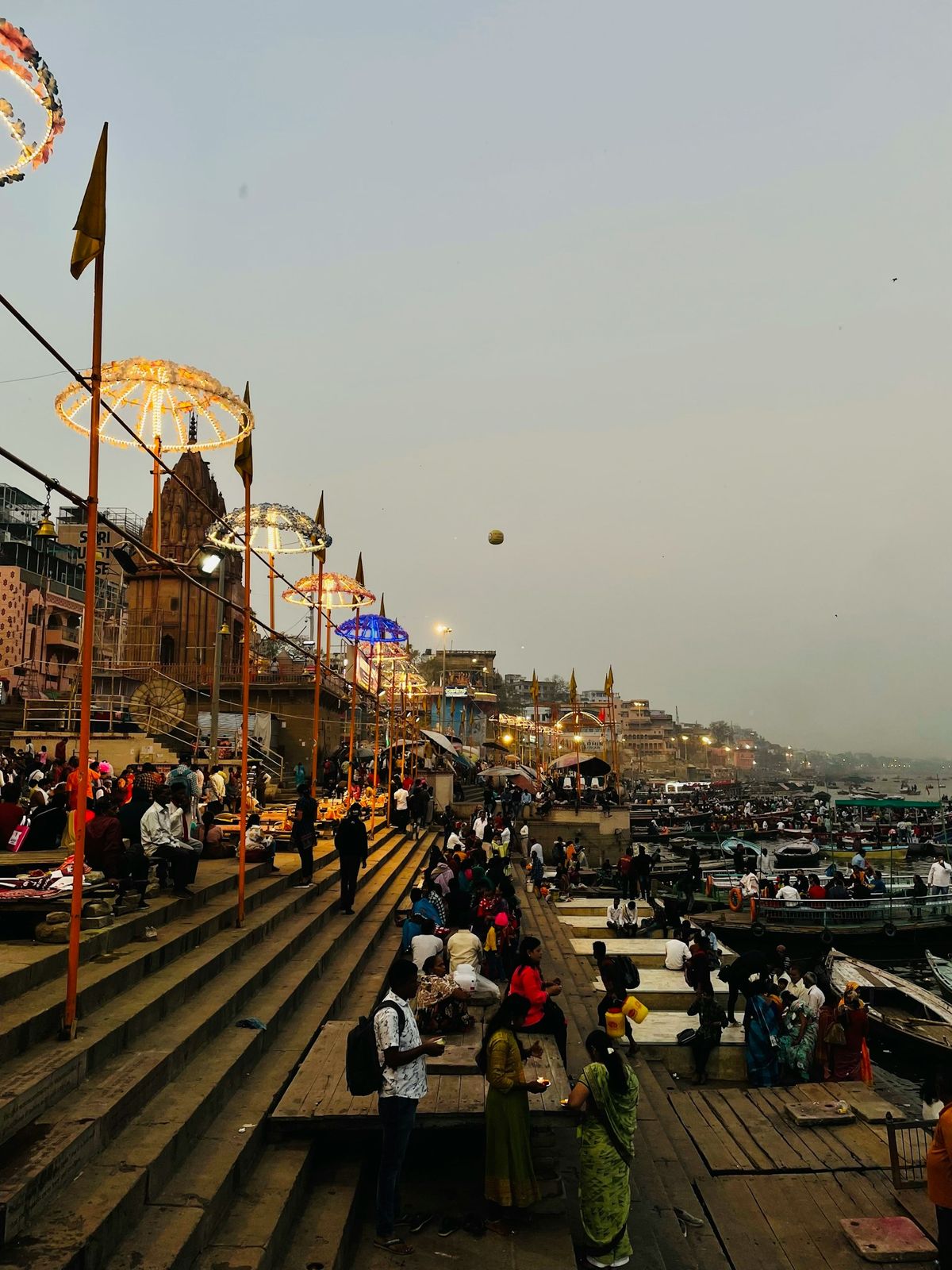 Pilgrims gathered on the stone steps of a ghat in Varanasi, India