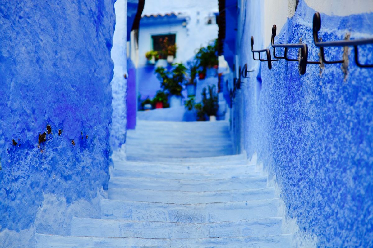 Narrow blue-painted alley and steps in Chefchaouen, Morocco