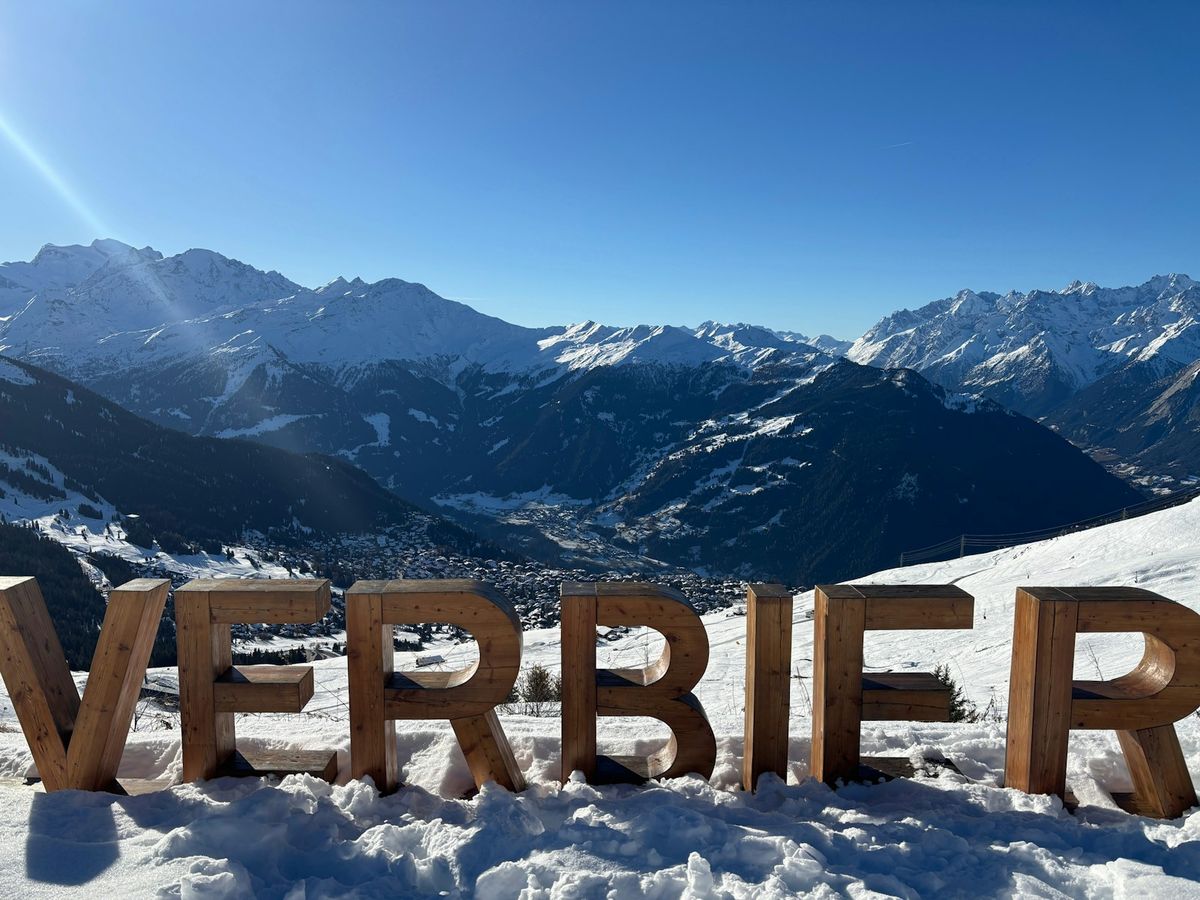 Verbier sign with snowy Swiss Alps peaks behind