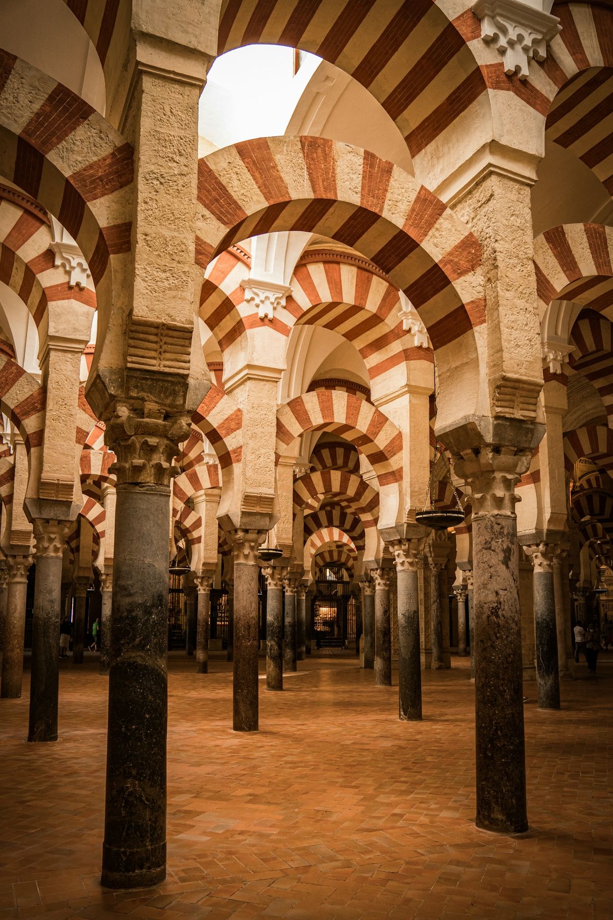 The iconic red and white striped arches inside the Mezquita-Catedral of Cordoba, Spain