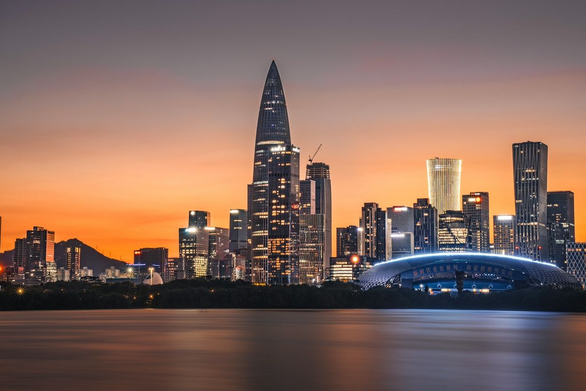 Shenzhen skyline with skyscrapers at sunset over water